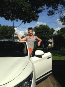 A young woman standing next to her white car