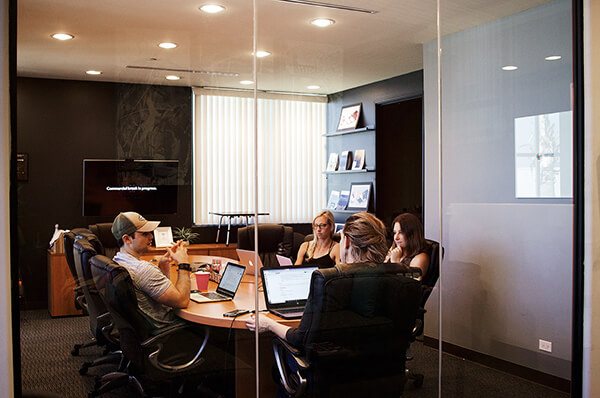 Group of employees in a small conference room