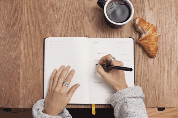 Woman adding a plan to her planner