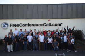 The free conference call team posing for a group photo