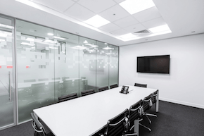 An empty conference room with tables and chairs