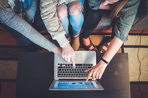 Girls pointing to a laptop screen