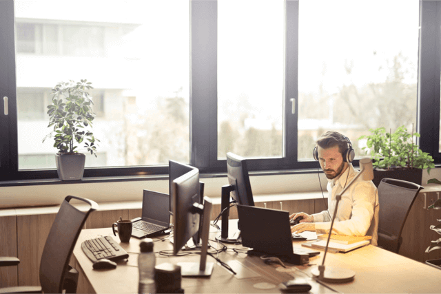 man with headset on the computer