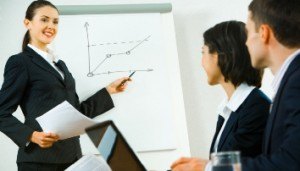 A woman presenting to her collegues in a meeting