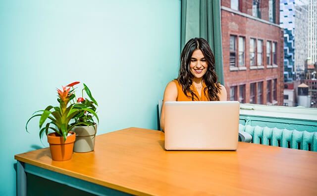 A Woman using a laptop in the room