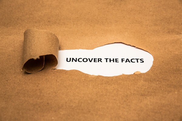 Tornpaper shows the word 'uncover the facts'