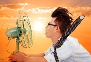 the heat wave is coming, business man holding a electric fan